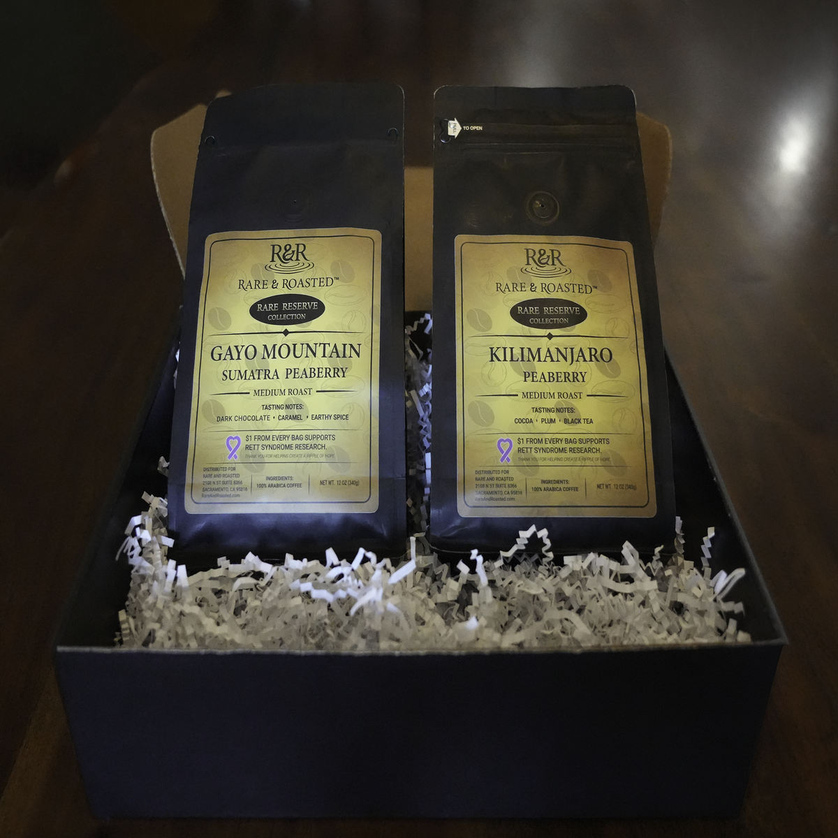 Rare & Roasted gift box with Kilimanjaro Peaberry and Gayo Mountain Peaberry coffee bags nestled in crinkle paper